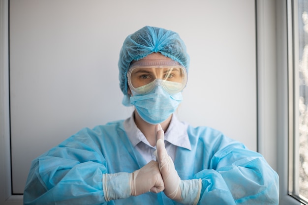 Shot of a female wearing a medical personnel protection equipment