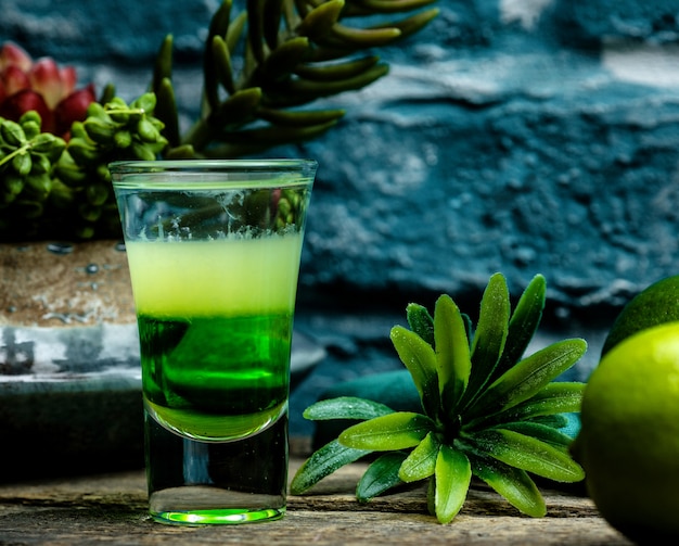 Shot of green cocktail with herbs