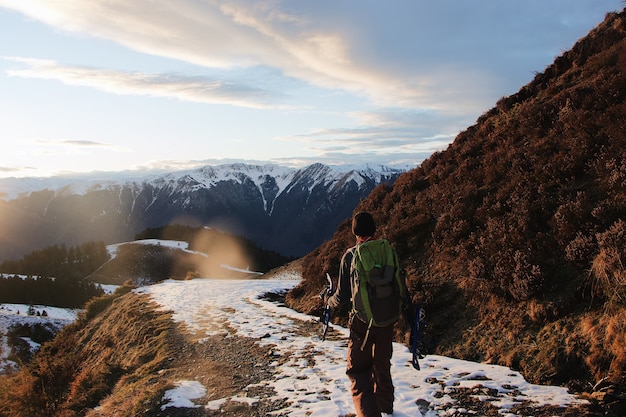 Free Photo behind shot of the hiker in the mountains covered in snow