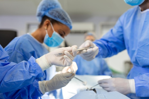 Shot in the Operating Room Assistant Hands out Instruments to Surgeons During Operation Surgeons Perform Operation Professional Medical Doctors Performing Surgery