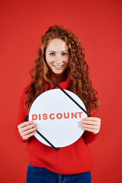 Free Photo shot of smiling woman showing banner of winter sale