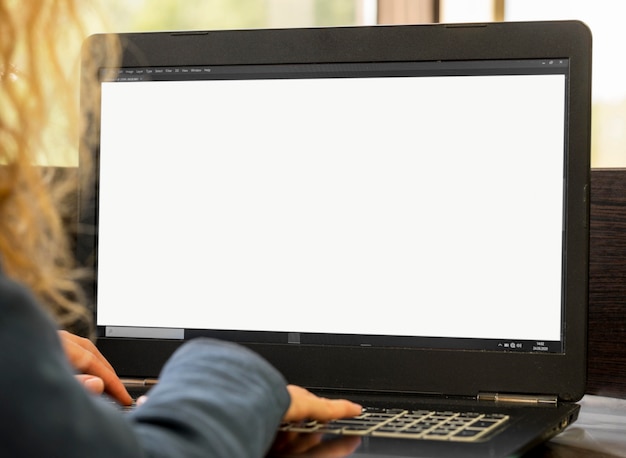 Over the shoulder businesswoman working on her laptop