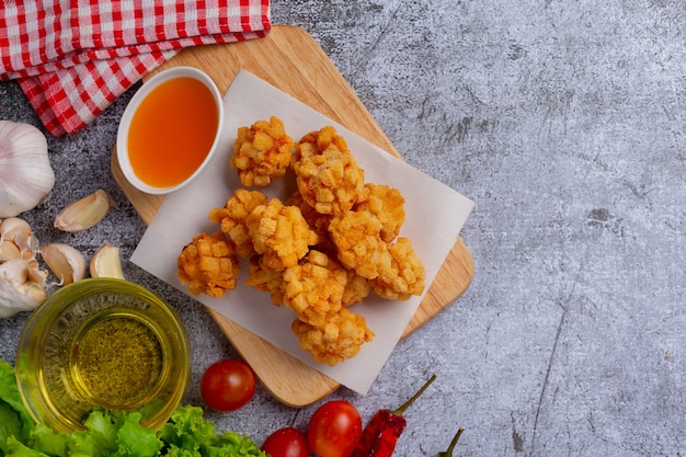 Shrimp balls covered with breaded fried on the dark surface.