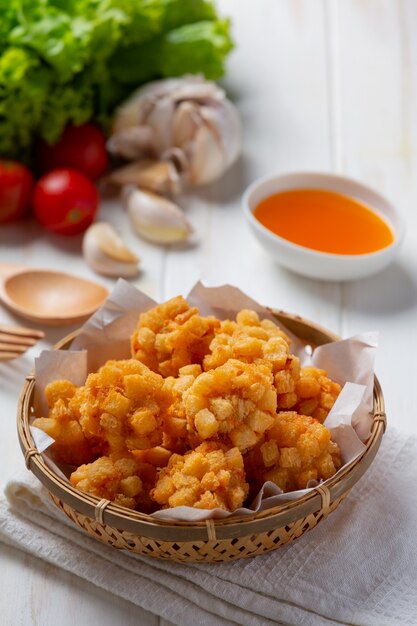 Shrimp balls covered with breaded fried on the white wooden surface.