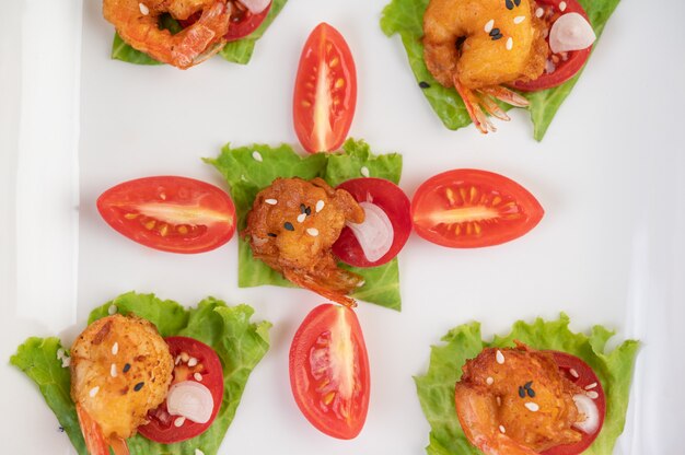 Shrimp deep-fried batter arranged beautifully in a white dish.