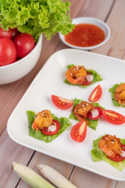 Shrimp deep-fried batter arranged beautifully in a white dish.