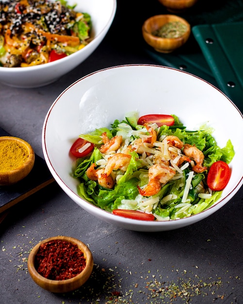 Shrimp salad with lettuce tomatoes and grated cheese