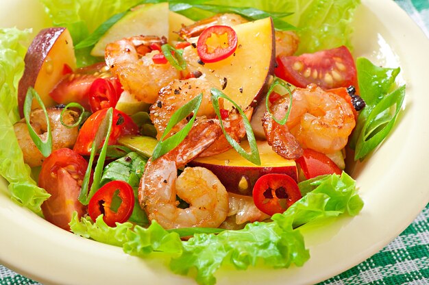 Shrimp salad with peaches, tomato, avocado and lettuce