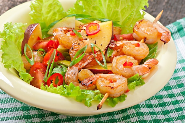 Shrimp salad with peaches, tomato, avocado and lettuce