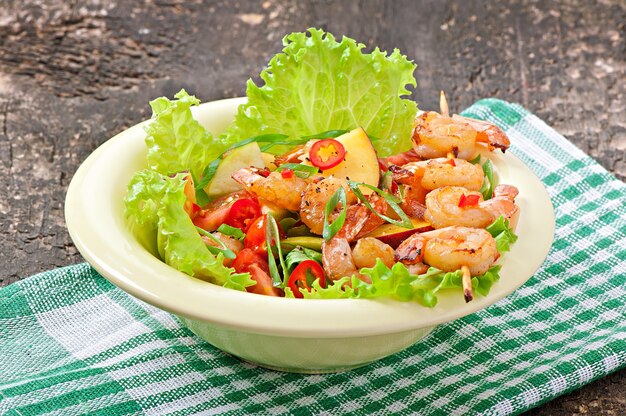 Shrimp salad with peaches, tomato, avocado and lettuce