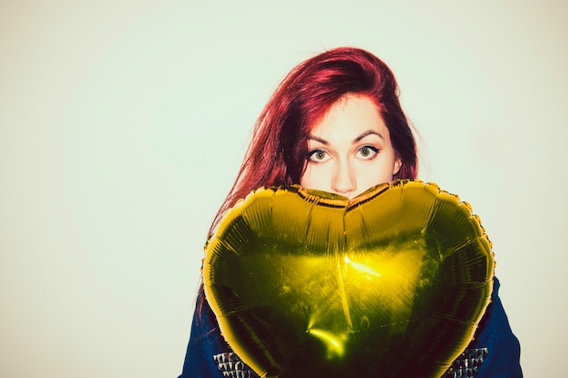 Free photo shy woman hiding with a balloon