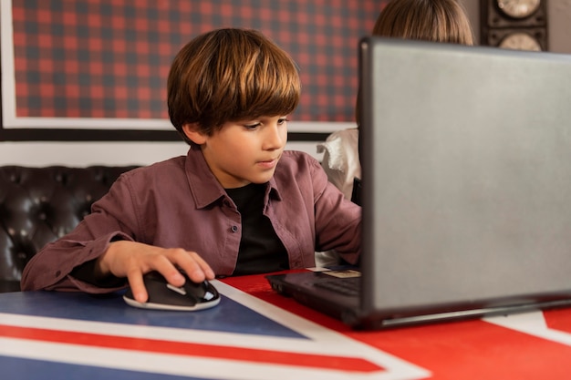 Siblings at home using laptop