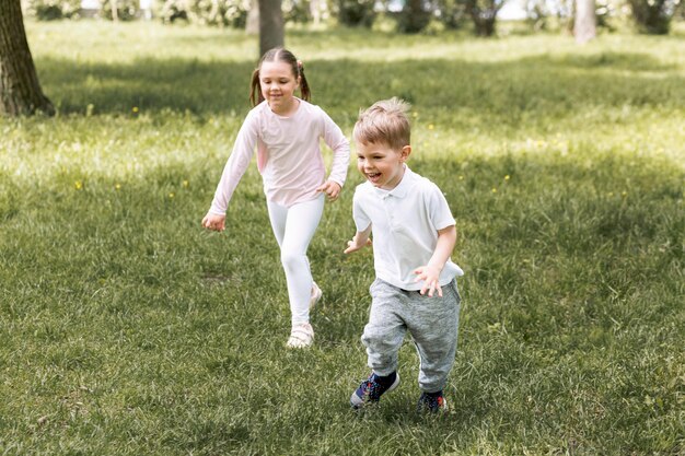 Siblings running in the park