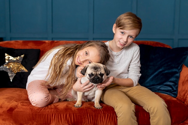 Free Photo siblings spending time together with their adorable dog