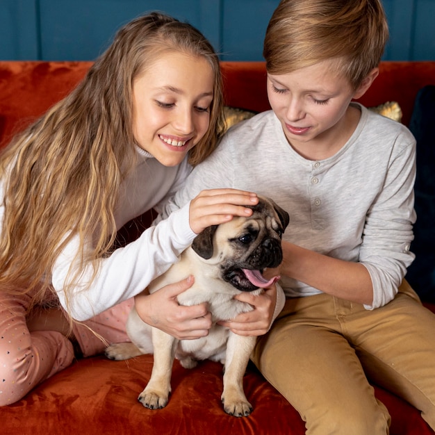 Free photo siblings spending time together with their dog