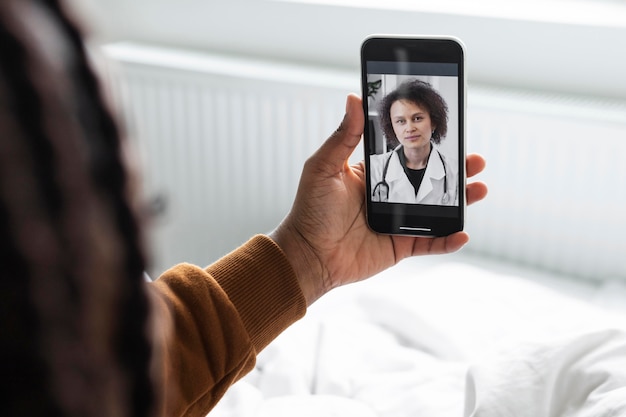 Free Photo sick man having a video call with a doctor