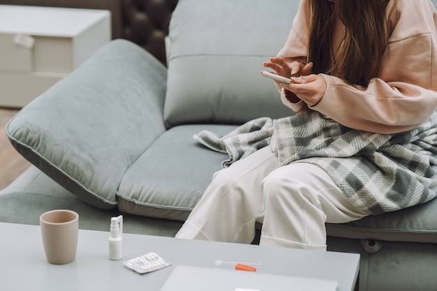 Sick woman with headache sitting at home