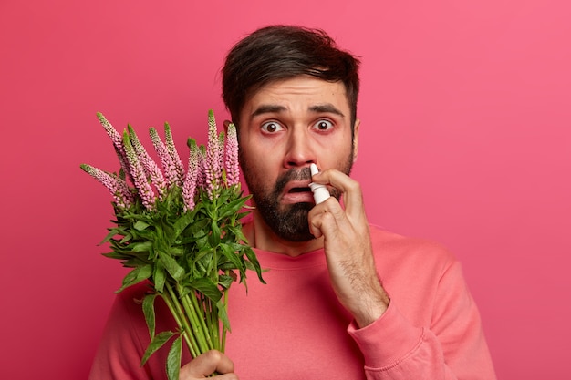 Sick young man suffering from allergy isolated