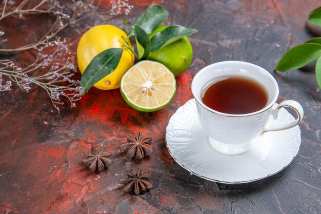 Side close-up view a cup of tea a cup of tea citrus fruits with leaves star anise on the table