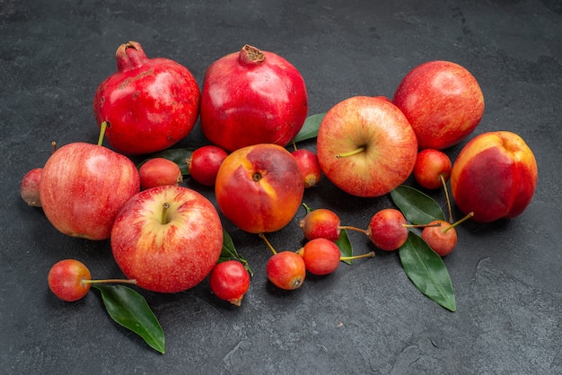 Side close-up view fruits the appetizing cherries nectarines apples pomegranates