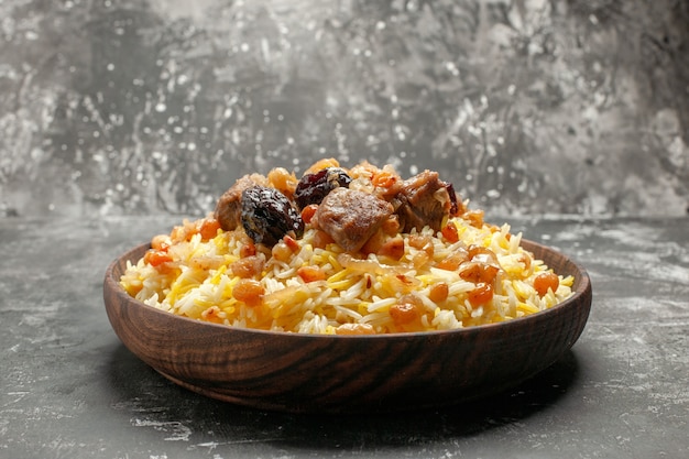 Side close-up view pilaf an appetizing pilaf with rice meat and dried fruits