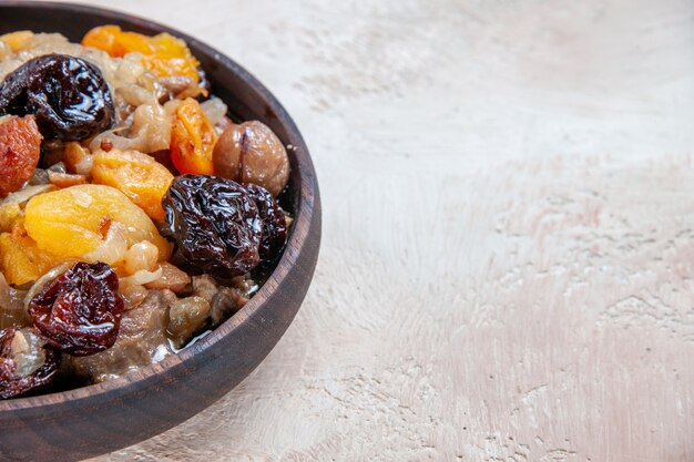 Side close-up view pilaf rice chestnuts dried fruits on the table