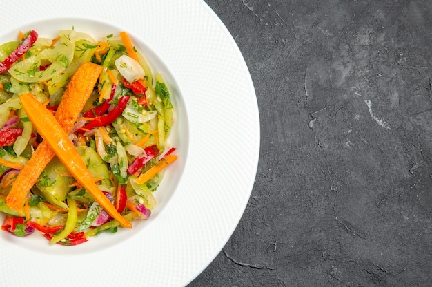 Side close-up view salad plate of an appetizing salad with carrots bell peppers