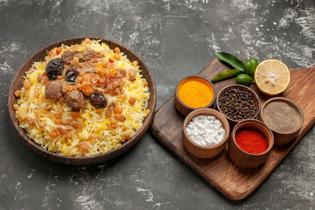 Free Photo side close-up view spices colorful spices on the board an appetizing pilaf on the cutting board