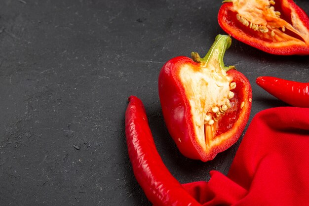 Side close-up view vegetables red hot peppers bell peppers tablecloth