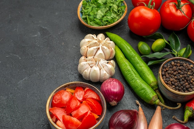 Side close-up view vegetables tomatoes hot peppers herbs spices citrus fruits with leaves