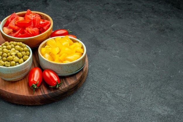 Side close view of vegetables on plate stand on dark grey background