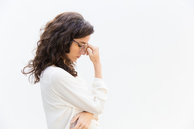 Side of tired sad office worker in glasses with closed eyes