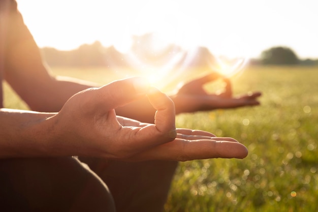 Side view adult meditating outdoors