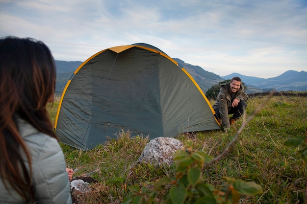 Free Photo side view adventurous couple bivouacking