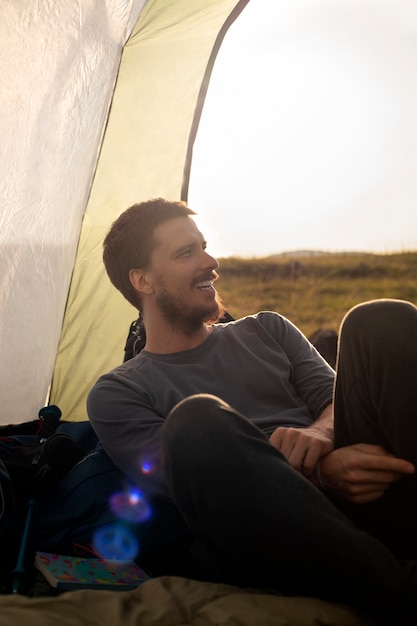 Free photo side view adventurous man bivouacking