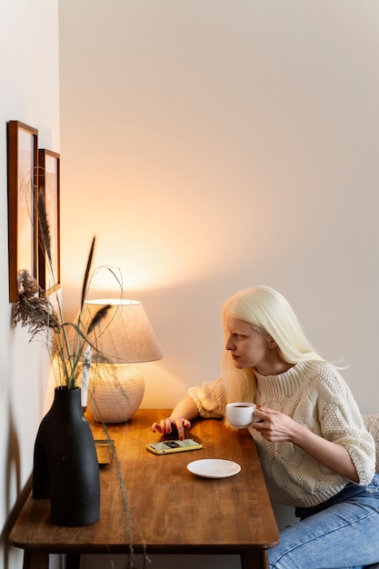 Side view albino woman sitting at table