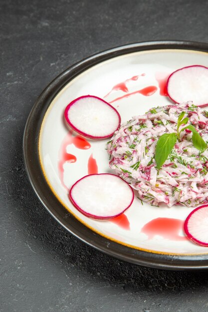 Side view an appetizing dish dish of radish and herbs with sauce on the plate