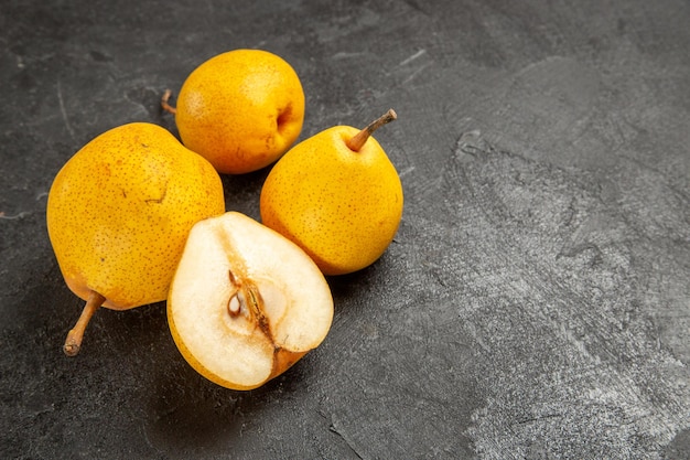 Side view appetizing pears appetizing pears and half a pear on the dark surface