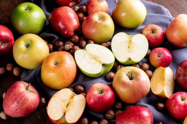 Side view apples with nuts on gray cloth  horizontal