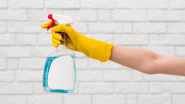 Side view of arm with glove holing cleaning solution