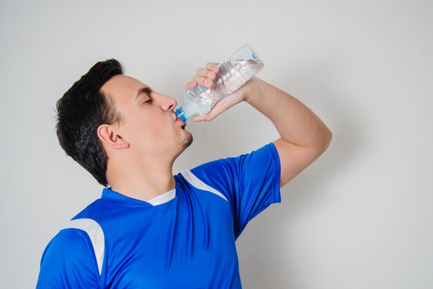 Side view of athlete drinking