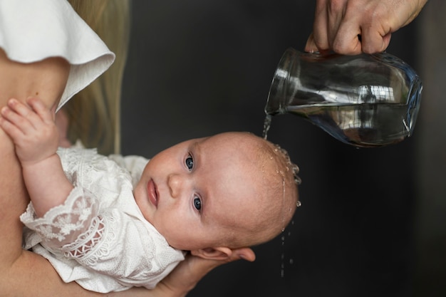 Side view baby baptism scene