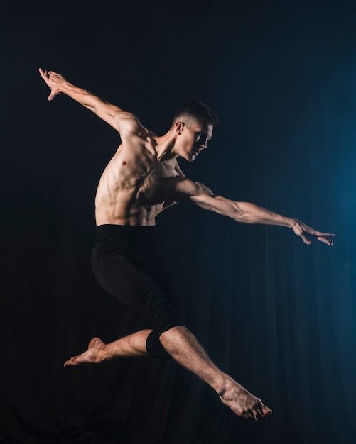 Side view of ballerino dancing in tights