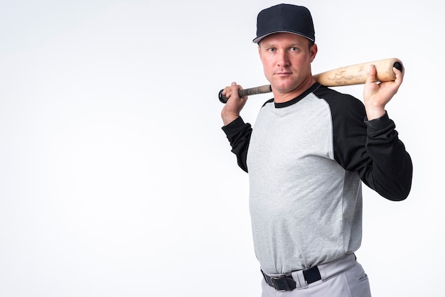 Free photo side view of baseball player with cap and bat