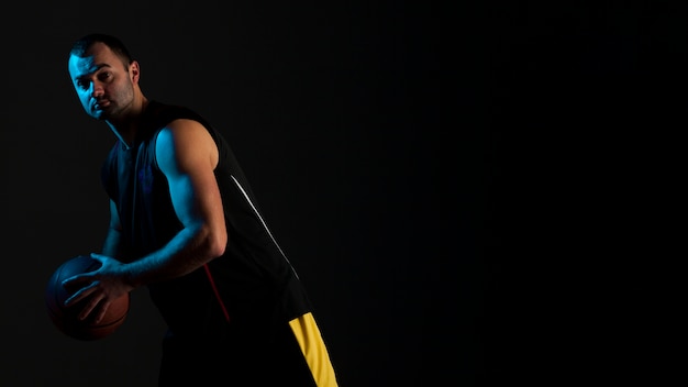 Side view of basketball player posing with copy space