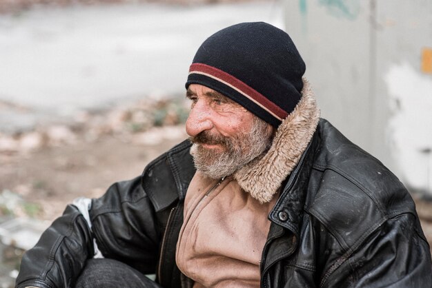 Side view of bearded homeless man outdoors