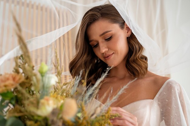 Side view beautiful bride holding flowers