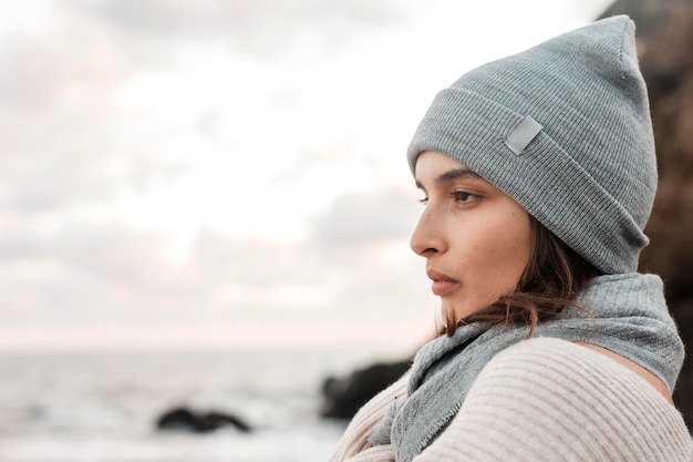 Side view of beautiful woman posing at the beach with copy space