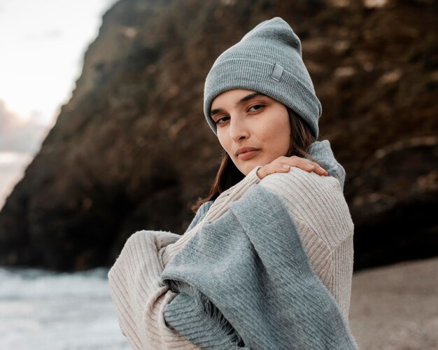 Side view of beautiful woman posing at the beach