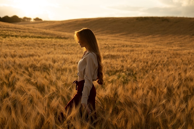 Free Photo side view beautiful woman posing at sunset